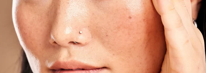 Closeup face, hand frame and asian woman in studio with skincare, skin glow or healthy cosmetics. H.